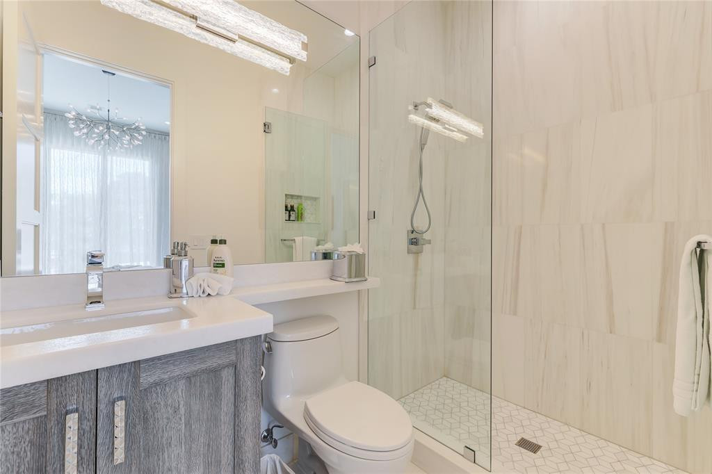 2550 Northeast 31st Court Lighthouse Point, FL 33064 - Photo 59 of 84 a bathroom with a sink a toilet and shower
