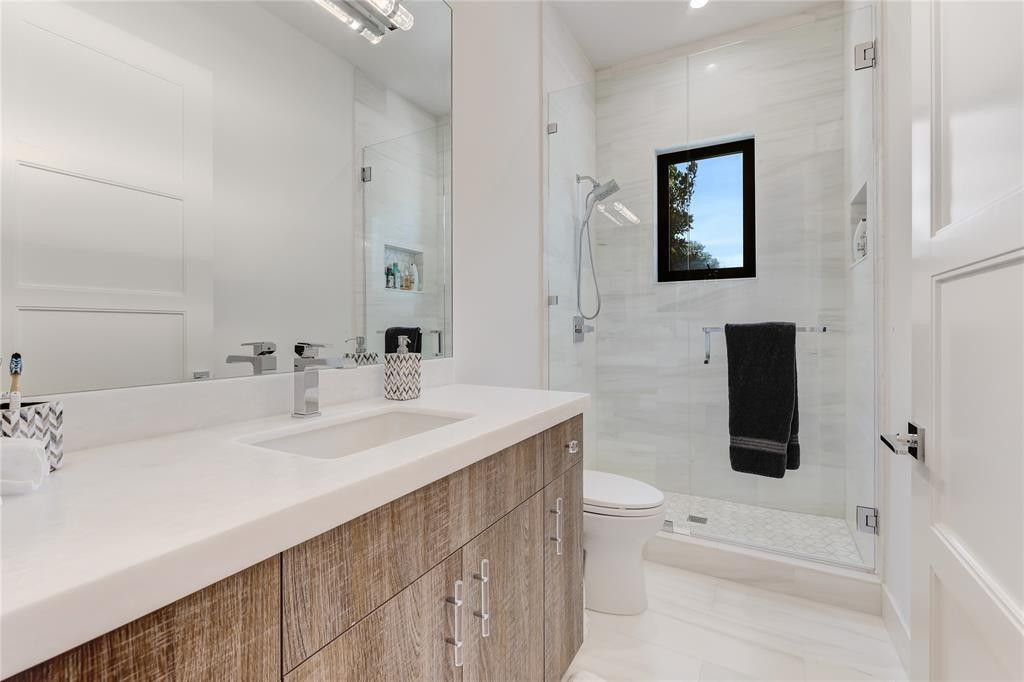 2550 Northeast 31st Court Lighthouse Point, FL 33064 - Photo 62 of 84 a bathroom with a sink a toilet and shower