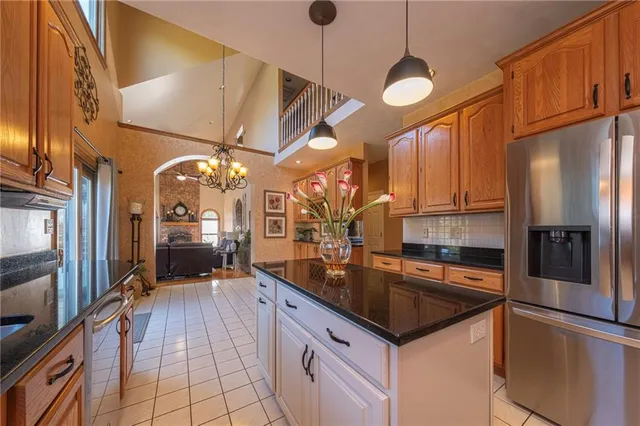 a kitchen with stainless steel appliances granite countertop a sink a counter space and cabinets