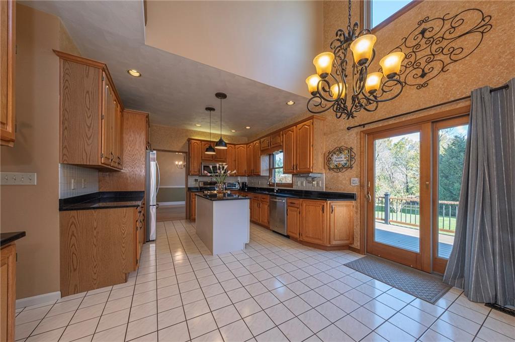 309 Jefferson Street Export, PA 15632 - Photo 12 of 43 a kitchen with stainless steel appliances granite countertop a refrigerator a sink dishwasher a oven with white cabinets and countertops