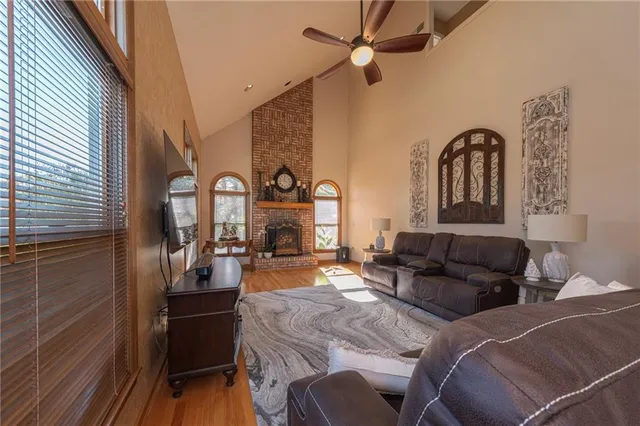 a living room with furniture a fireplace and wooden floor