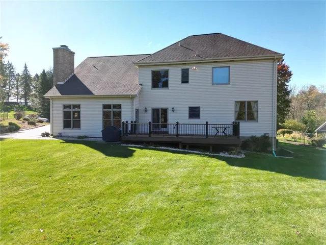 a view of a house with a yard patio and swimming pool