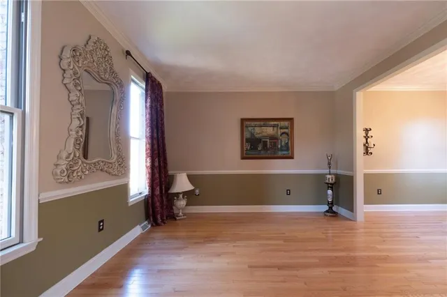 a view of a room with wooden floor and a window
