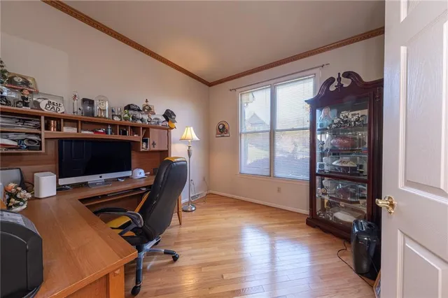 a view of a workspace with furniture and a window