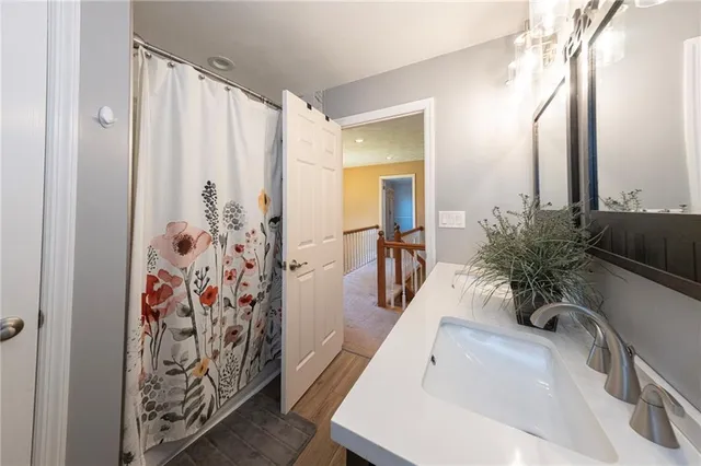 a bathroom with a sink a mirror and a shower