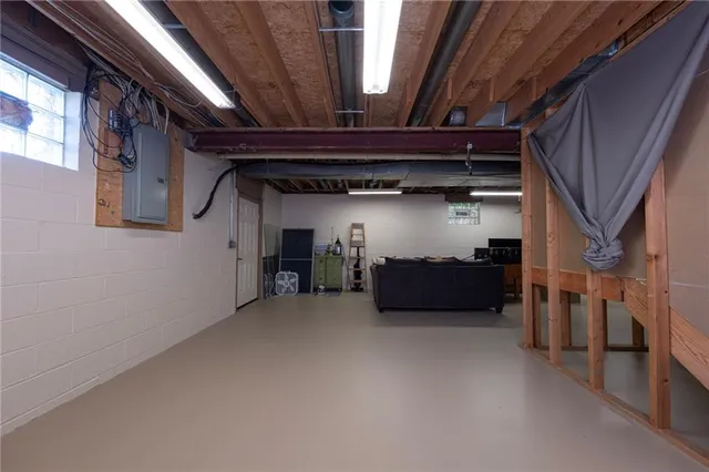 a view of an empty room with wooden stairs