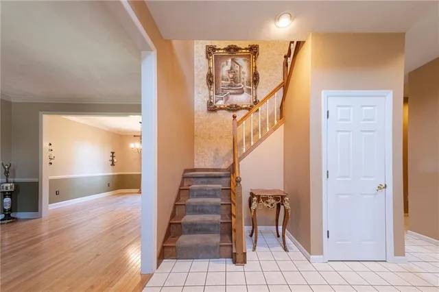 a view of entryway and hall with wooden floor