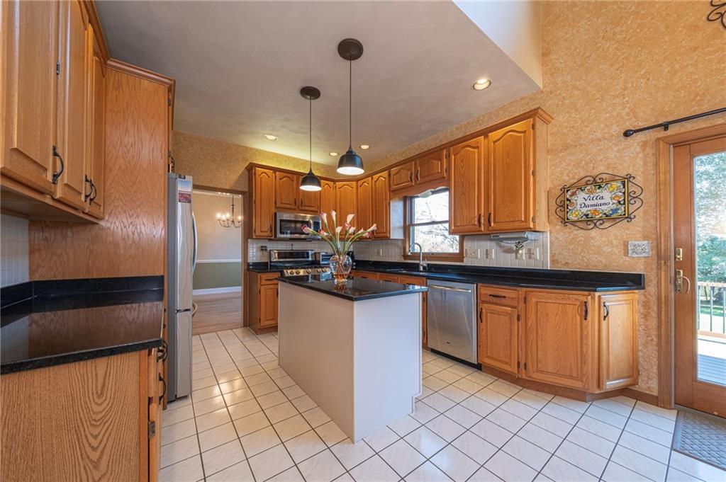 309 Jefferson Street Export, PA 15632 - Photo 10 of 43 a kitchen with stainless steel appliances granite countertop a refrigerator and a sink