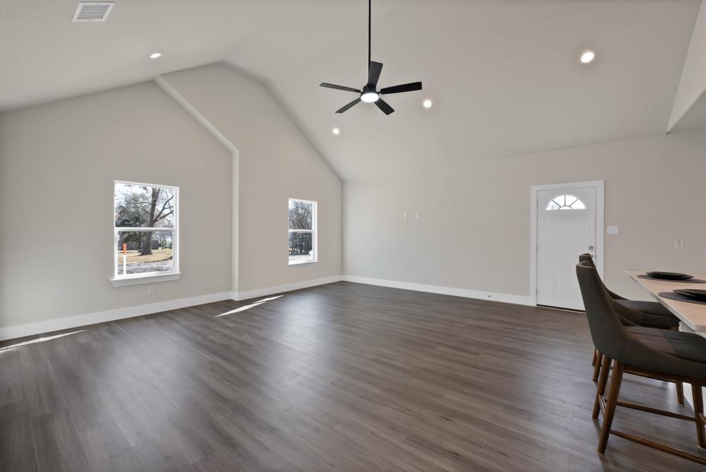 200 Harris Harbor Road East Tawakoni, TX 75472 - Photo 11 of 24 a view of a room with wooden floor a ceiling fan and windows