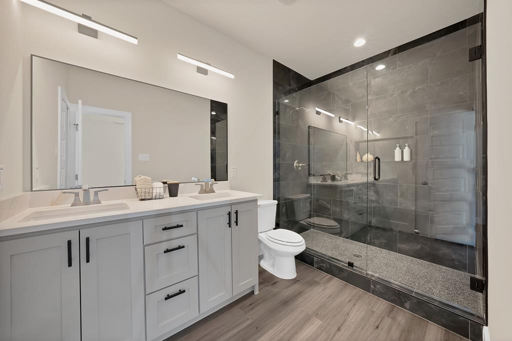 200 Harris Harbor Road East Tawakoni, TX 75472 - Photo 15 of 24 a bathroom with a double vanity sink toilet a mirror and shower