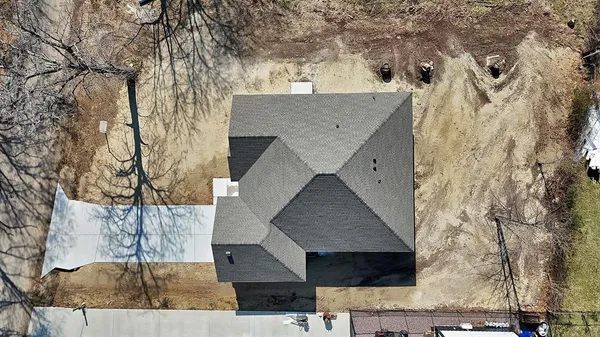 an aerial view of a house with a yard