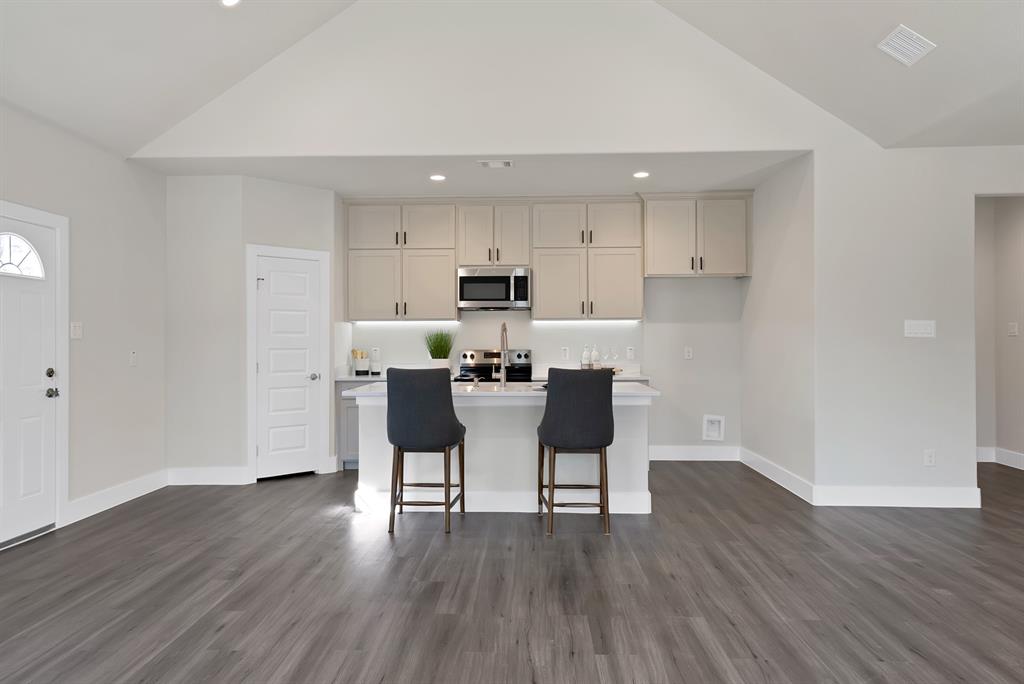 200 Harris Harbor Road East Tawakoni, TX 75472 - Photo 4 of 24 a kitchen with stainless steel appliances wooden floors and refrigerator
