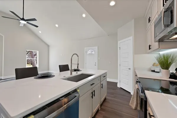 a kitchen that has a stove and a table