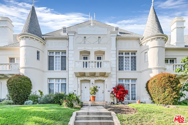 an empty room with wooden floor and natural light