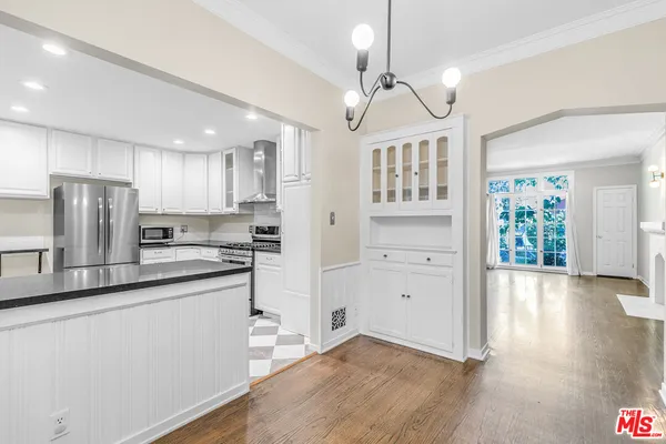a kitchen with stainless steel appliances granite countertop a sink a stove and a refrigerator