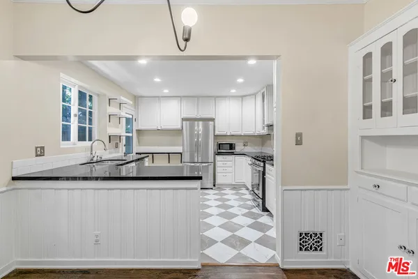 a kitchen with stainless steel appliances a sink and a refrigerator