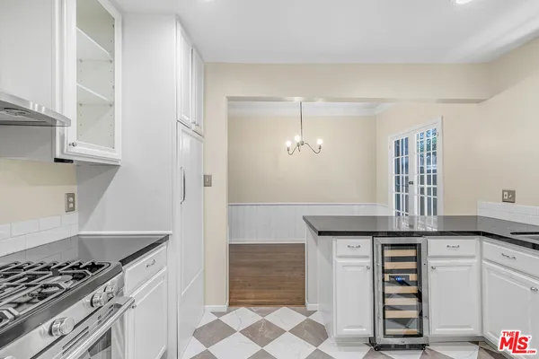 a kitchen with granite countertop a sink and cabinets