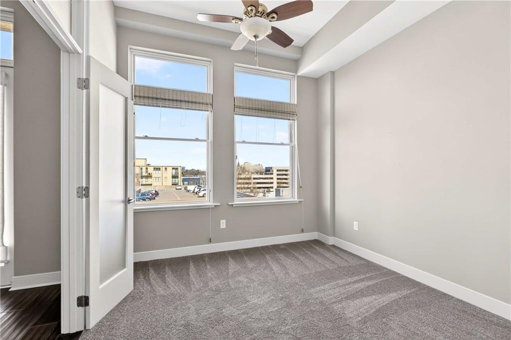 201 West Ponce De Leon Avenue, Unit 702 Decatur, GA 30030 - Photo 15 of 41 an empty room with a window and a ceiling fan