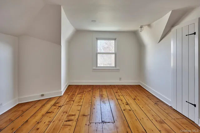 a view of a room with wooden floor and staircase