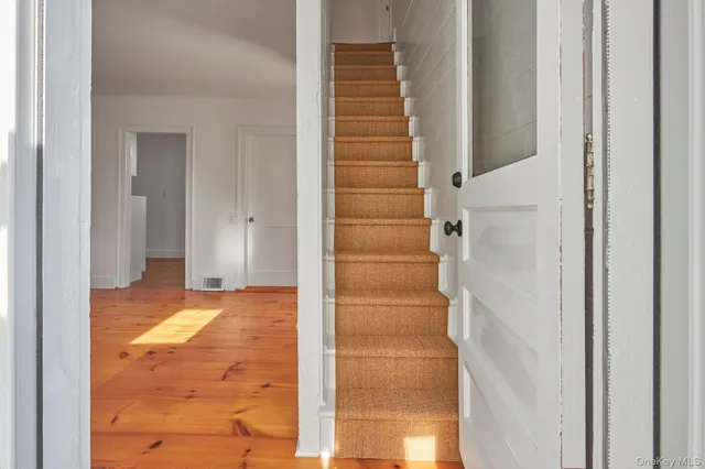 a view of entryway with bathroom and shower