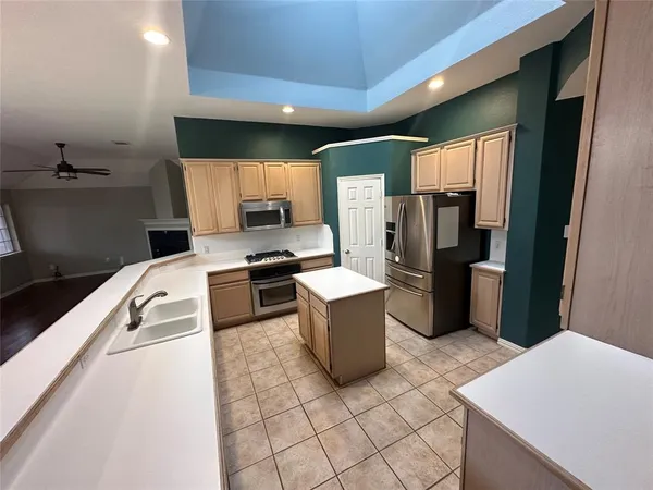 a kitchen with a refrigerator and a stove
