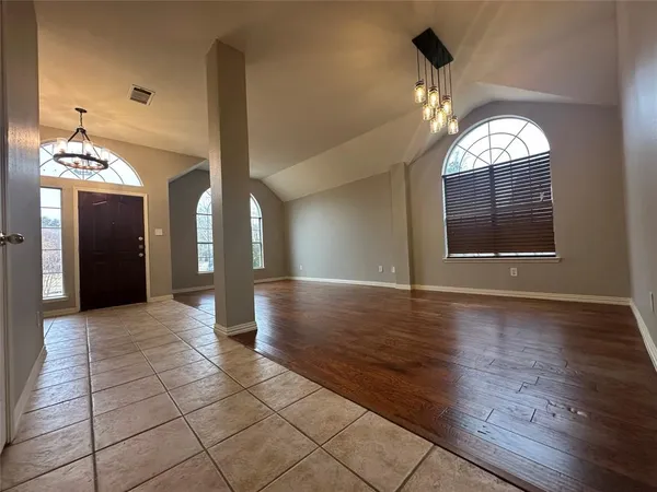 wooden floor in an empty room with a mirror