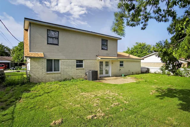 a view of a house with a big yard and large trees