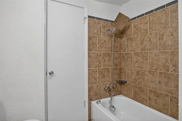 a view of a workspace with wooden floor and a window