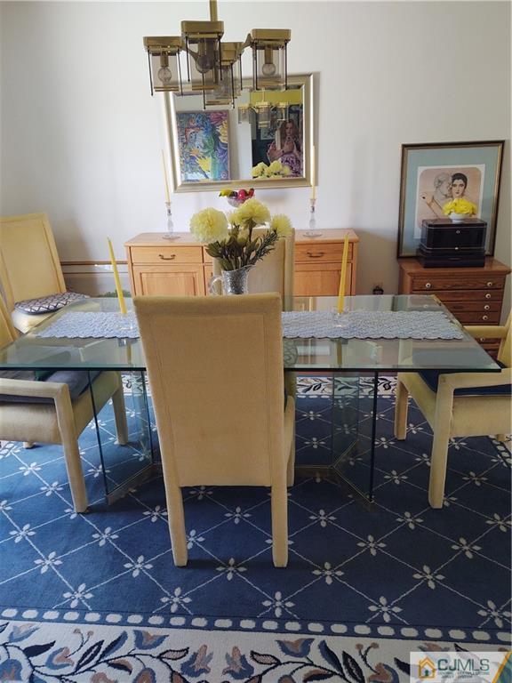 126 Moretti Lane Edison, NJ 08817 - Photo 12 of 33 a room with table chairs and wooden floor