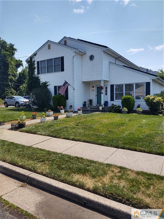 126 Moretti Lane Edison, NJ 08817 - Photo 2 of 33 a front view of a house with a yard and garage