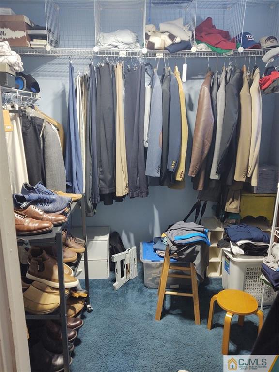 126 Moretti Lane Edison, NJ 08817 - Photo 23 of 33 a view of walk in closet with clothes
