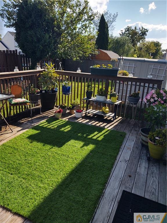 126 Moretti Lane Edison, NJ 08817 - Photo 29 of 33 a view of a chair and table on the wooden deck