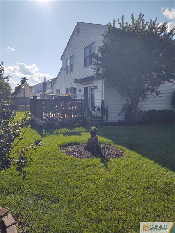126 Moretti Lane Edison, NJ 08817 - Photo 30 of 33 a view of a house with a big yard and a large tree