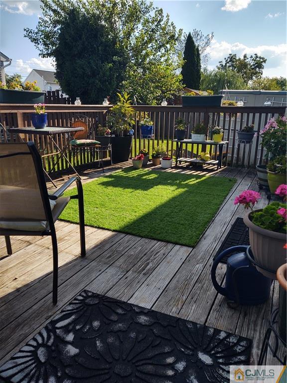 126 Moretti Lane Edison, NJ 08817 - Photo 31 of 33 a view of a wooden deck with furniture