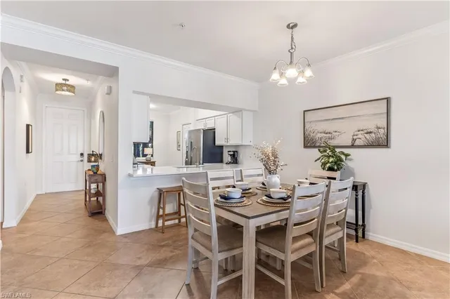 a view of a dining room with furniture and chandelier