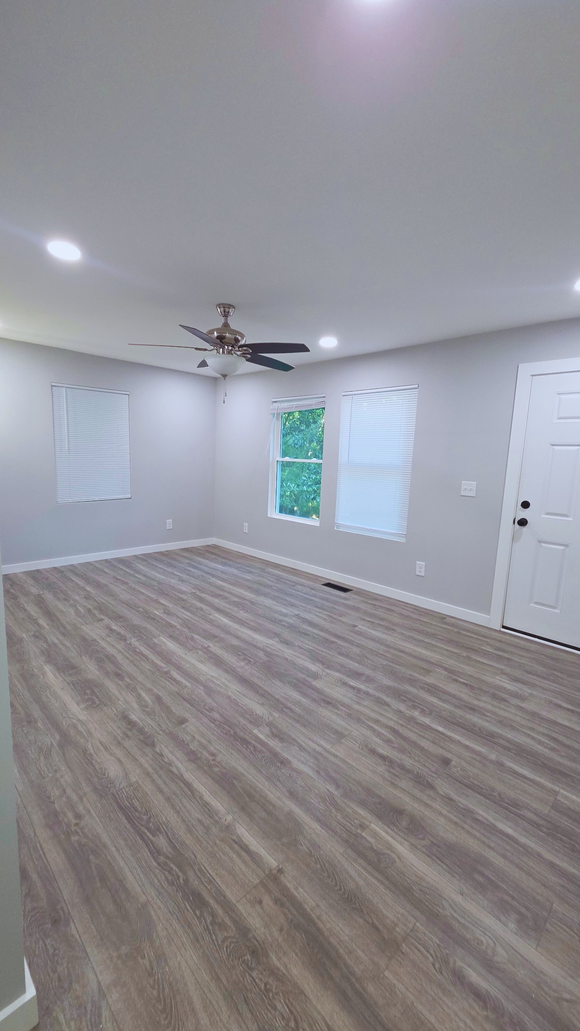 1080 Veterans Road Ashland City, TN 37015 - Photo 12 of 35 an empty room with wooden floor and windows