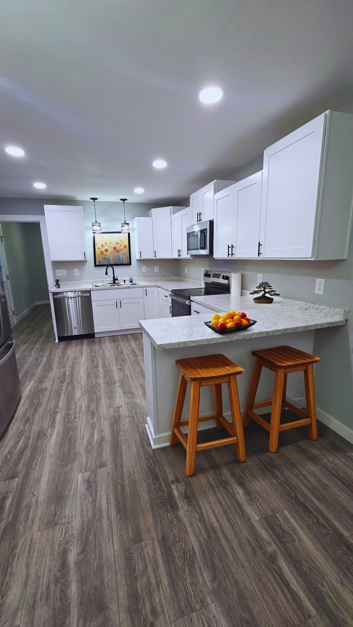1080 Veterans Road Ashland City, TN 37015 - Photo 16 of 35 a kitchen view with wooden floor and chairs