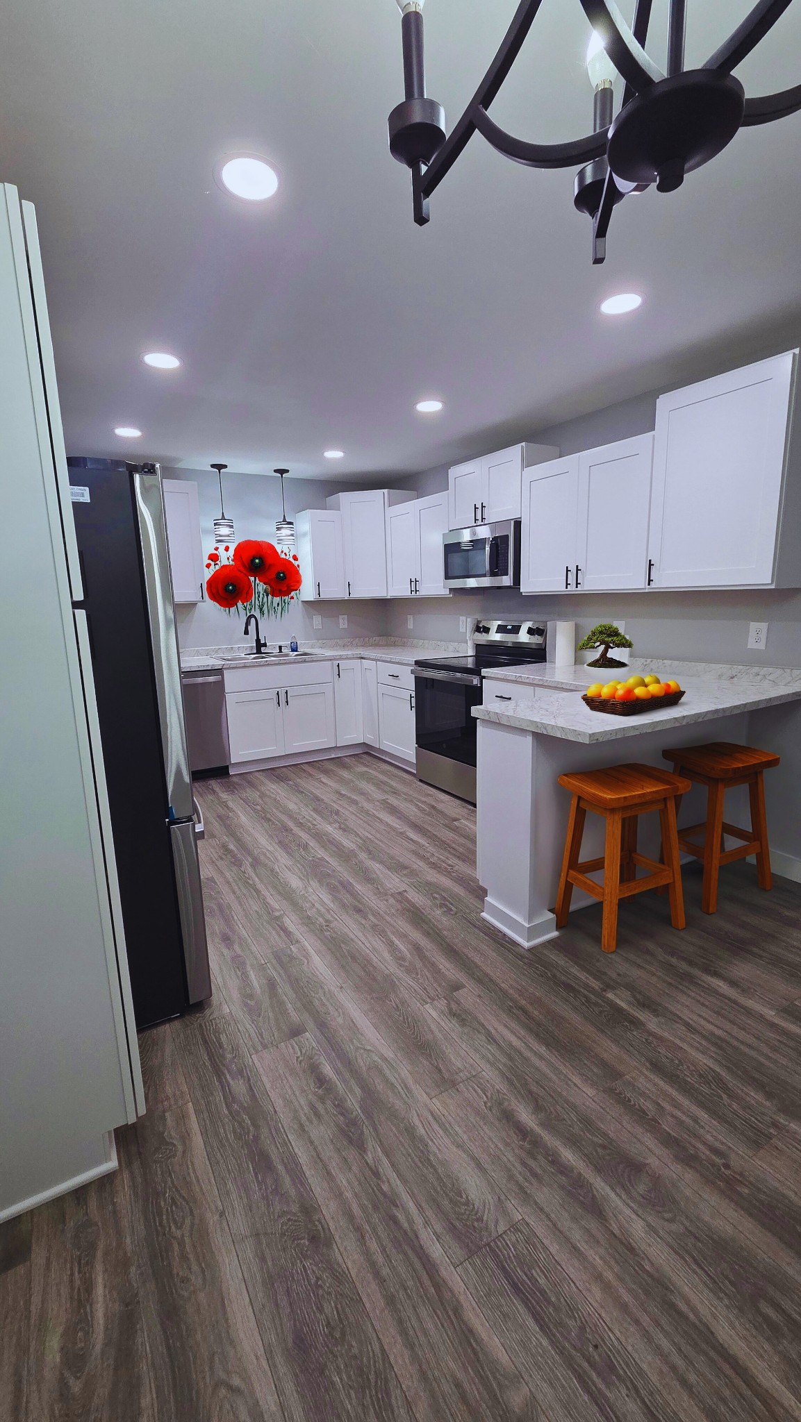 1080 Veterans Road Ashland City, TN 37015 - Photo 18 of 35 a living room with stainless steel appliances furniture a rug kitchen view and a chandelier