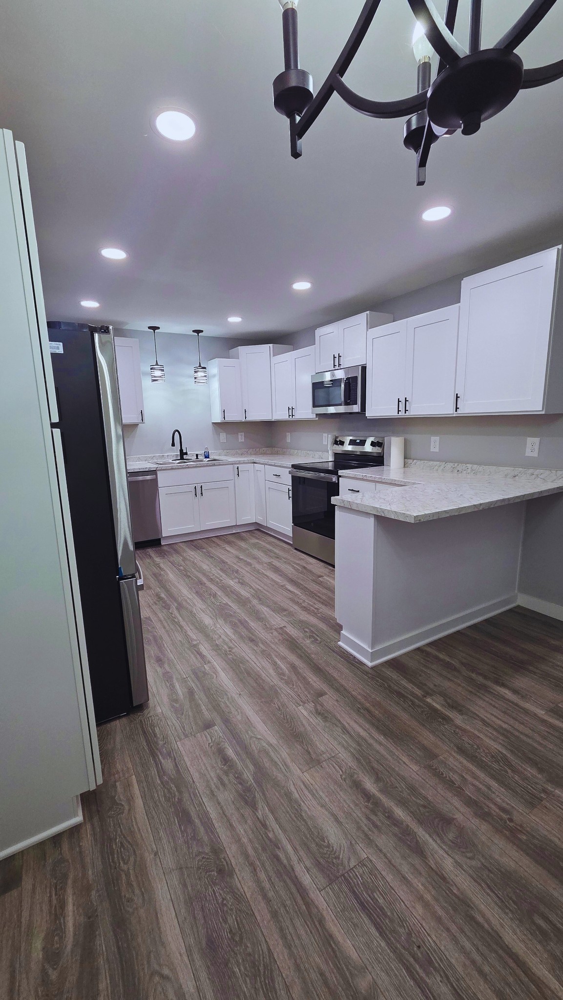 1080 Veterans Road Ashland City, TN 37015 - Photo 19 of 35 a view of a kitchen with wooden floor and stainless steel appliances