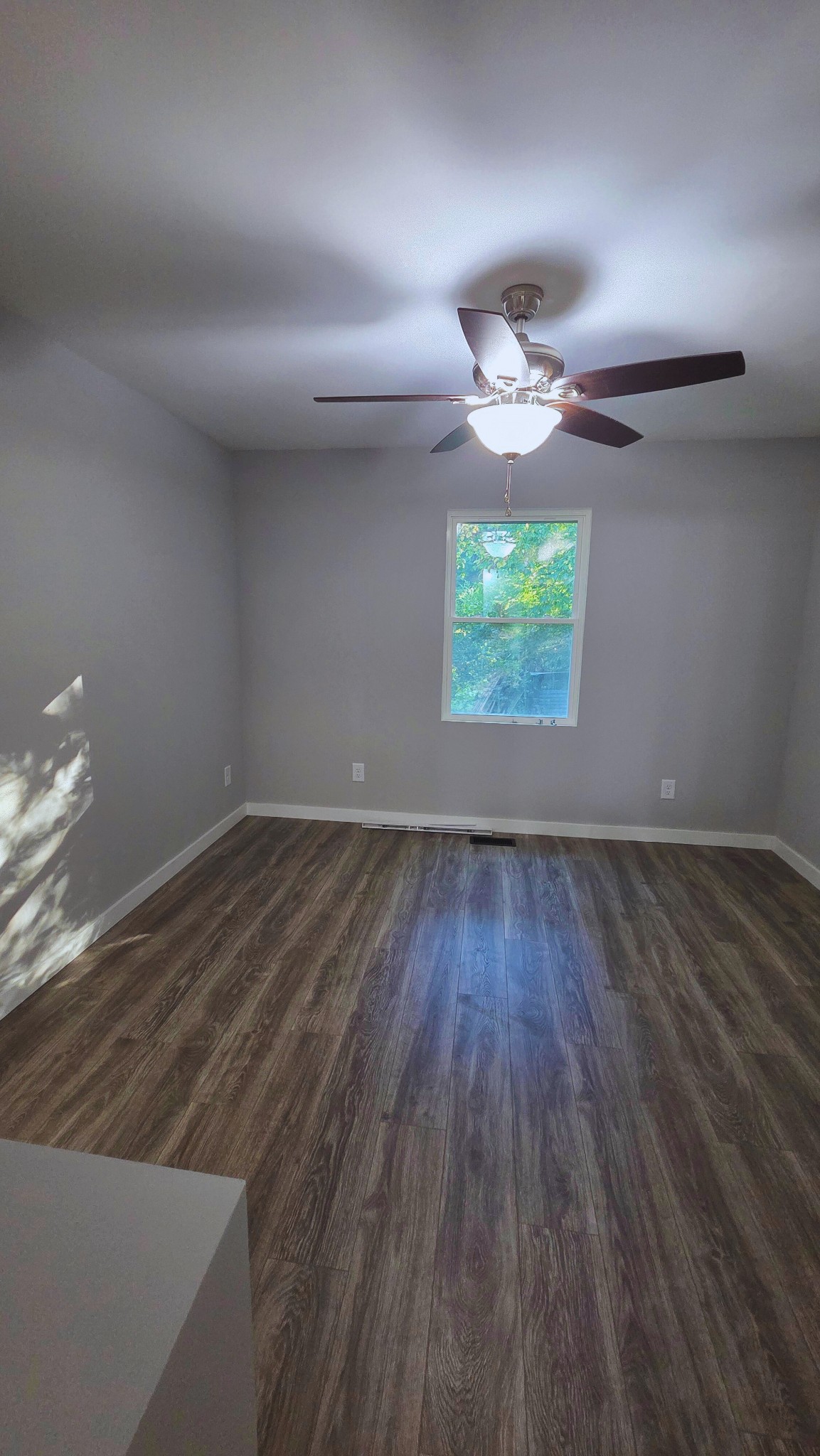 1080 Veterans Road Ashland City, TN 37015 - Photo 30 of 35 an empty room with wooden floor and windows