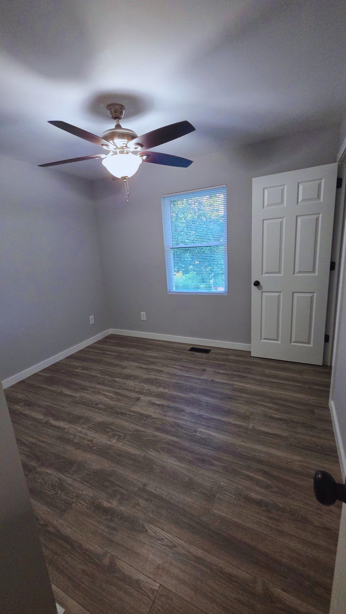 1080 Veterans Road Ashland City, TN 37015 - Photo 35 of 35 an empty room with wooden floor ceiling fan and windows