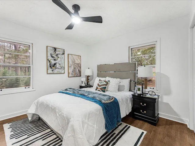 a bedroom with a bed and a ceiling fan