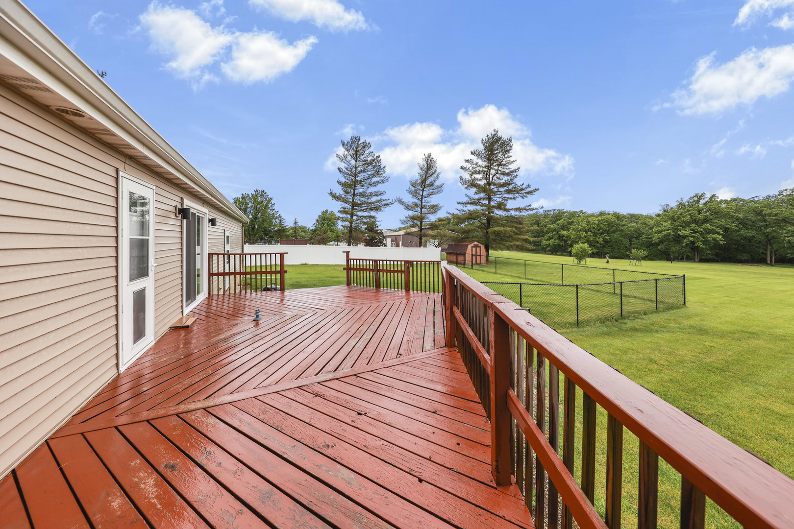 2433 East 2850th Road Marseilles, IL 61341 - Photo 17 of 20 a view of a house with wooden deck and a garden