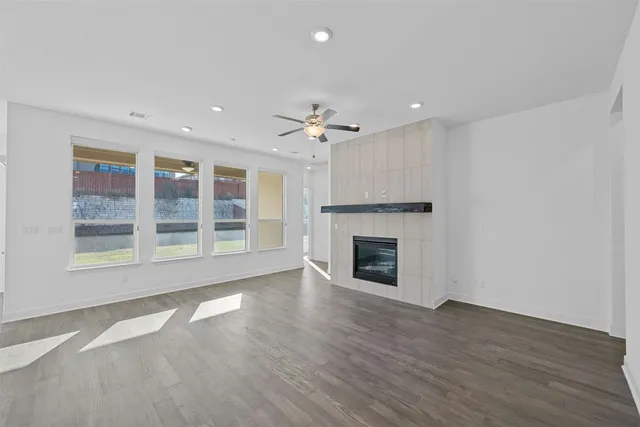 a view of an empty room with a fireplace and a window