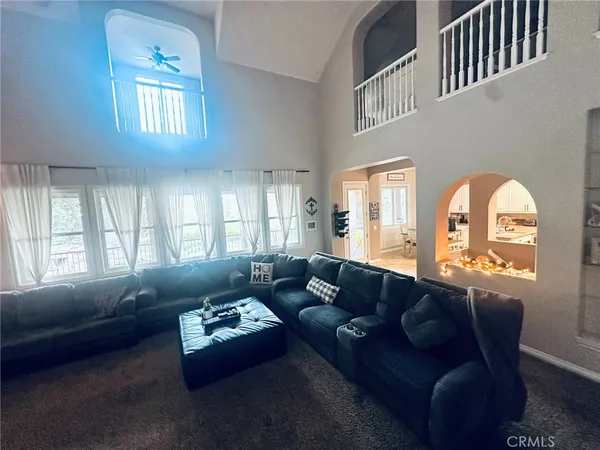 a living room with furniture and kitchen view