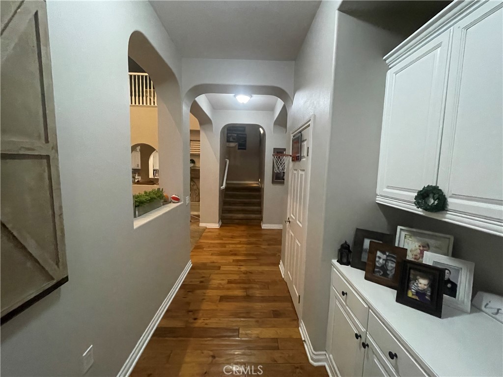 25452 Edna Road Murrieta, CA 92562 - Photo 17 of 70 a view of a hallway with wooden floor and cabinets