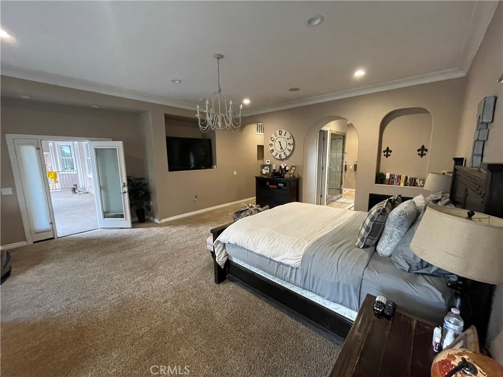 25452 Edna Road Murrieta, CA 92562 - Photo 21 of 70 a spacious bedroom with a bed a mirror and furniture