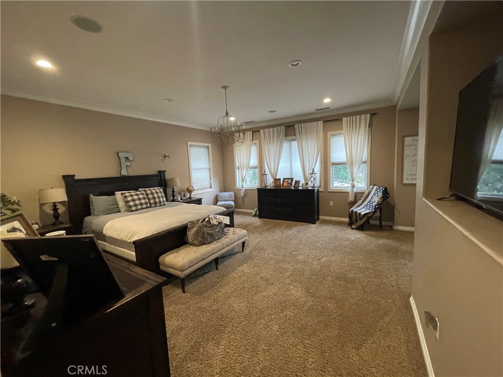 25452 Edna Road Murrieta, CA 92562 - Photo 22 of 70 a bedroom with a bed a couch and a flat tv screen on dresser