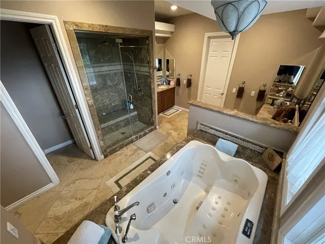 a bathroom with a sink a toilet a mirror and tub