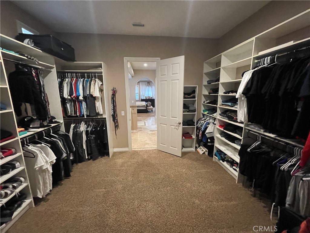 25452 Edna Road Murrieta, CA 92562 - Photo 27 of 70 a view of walk in closet with clothes and shoes